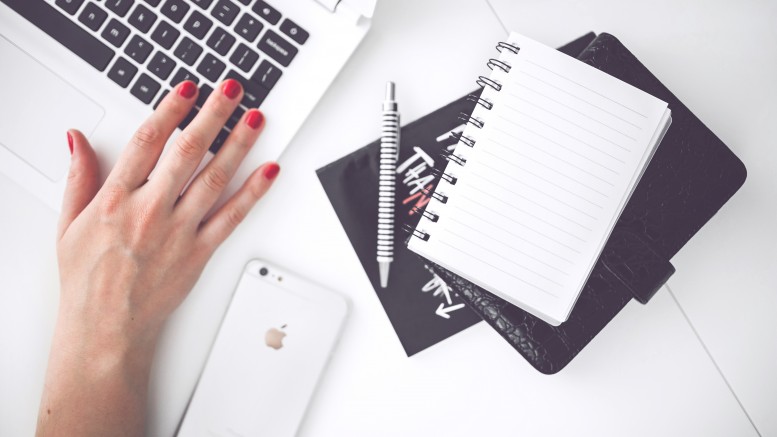 woman-hand-smartphone-desk