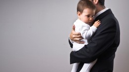 stock-photo-6538700-man-wearing-suit-holding-a-baby-2