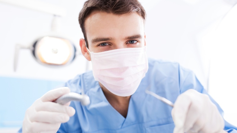 Dentist Holding Dental Tools