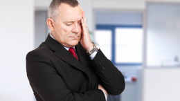 Senior stressed businessman in his office