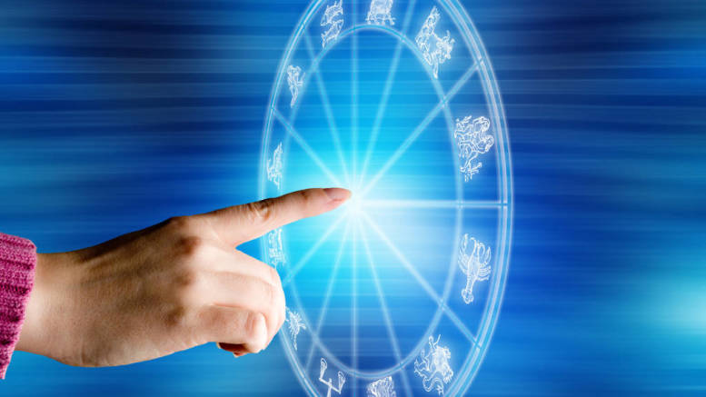 female hand touching a zodiac chart