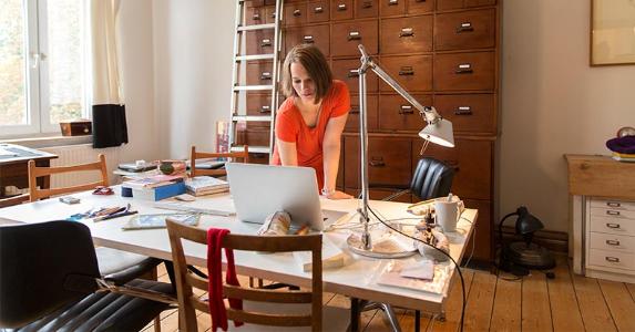 woman-working-in-home-office-file-cabinet-getty_573x300