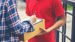 young-man-delivering-package-to-customer-at-home-delivery_1150-2963