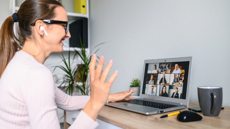 A woman is using laptop for video connection