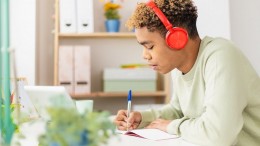 Young student man working on laptop in her studio room