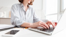 brunette-woman-typing-email-laptop-computer-while-sitting-home-selective-focus-hand