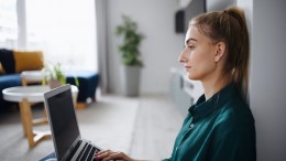 Young woman student with laptop at home, home office and learning.