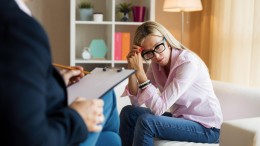 Young woman talking with psychotherapist